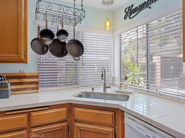 a kitchen with a sink cabinets and a window