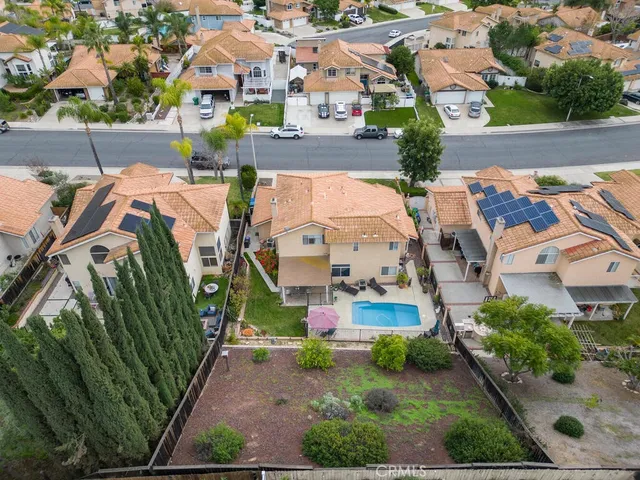 an aerial view of multiple houses with yard