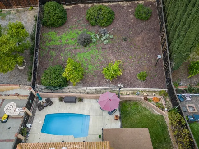 an aerial view of house with yard swimming pool and outdoor seating