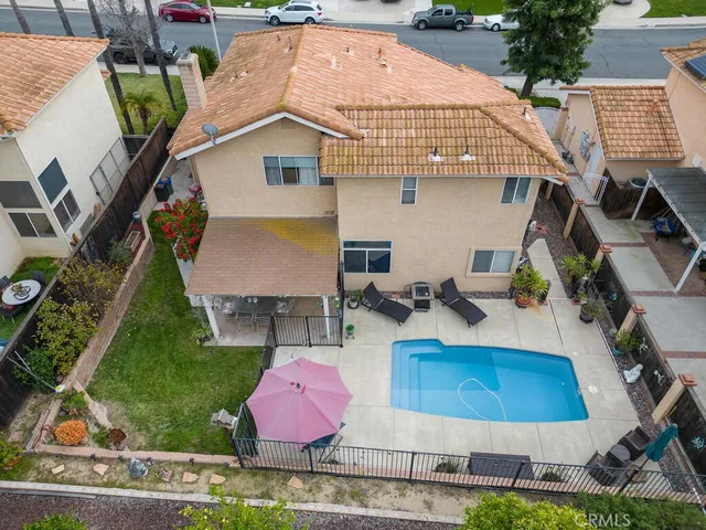 a view of a patio with table and chairs under an umbrella