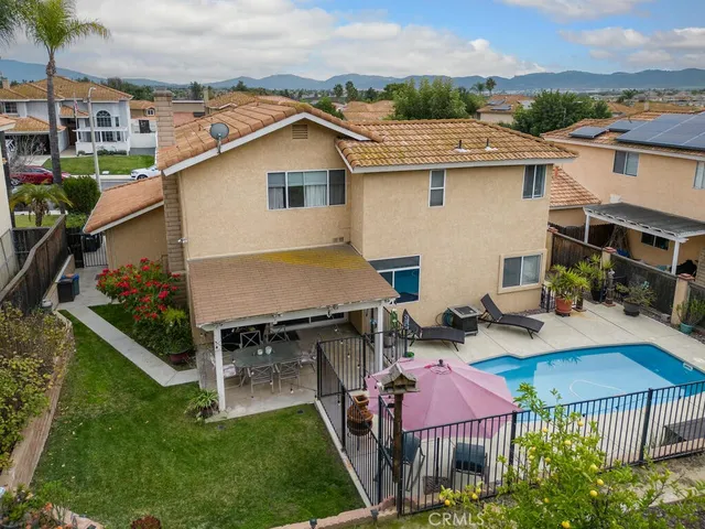 an aerial view of residential houses with outdoor space and swimming pool