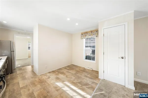 a view of an empty room with a cabinet