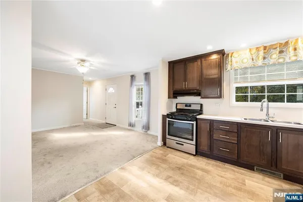 a kitchen with stainless steel appliances granite countertop a stove and a sink