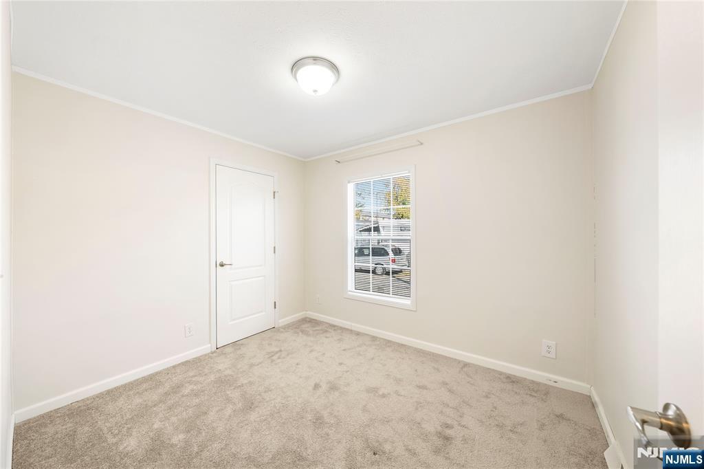 225 Albert Street Lodi, NJ 07644 - Photo 18 of 24 an empty room with windows