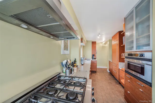 a view of a dining room with furniture a fireplace and wooden floor