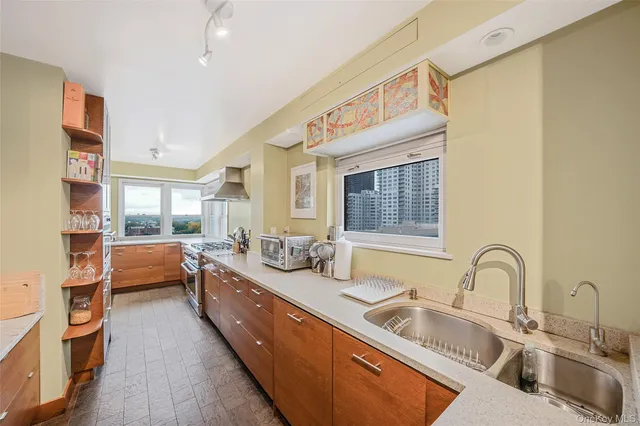 a large white kitchen with a large window