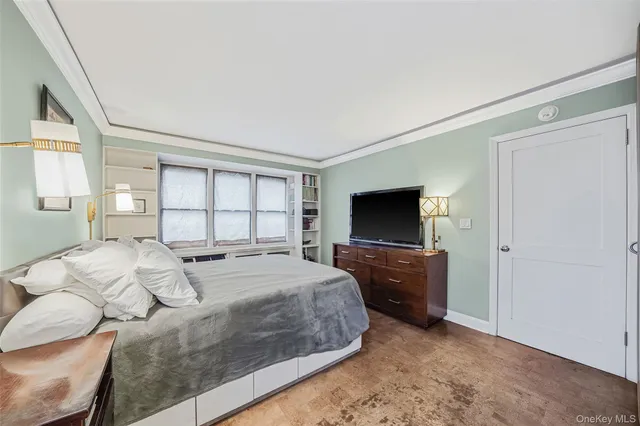 a bedroom with a bed and a television in it