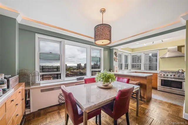 a dining room with furniture a chandelier and wooden floor