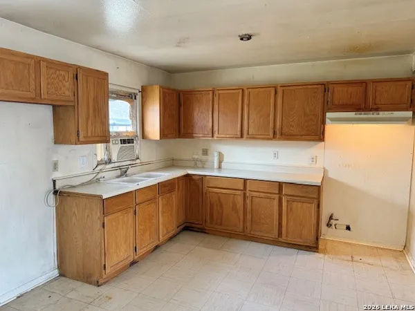 a kitchen that has a sink and a stove in it