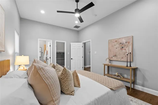 a bedroom with a large bed and a chandelier