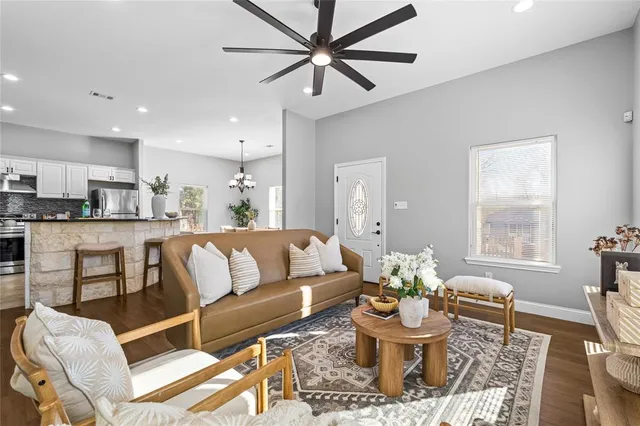 a living room with furniture and kitchen view