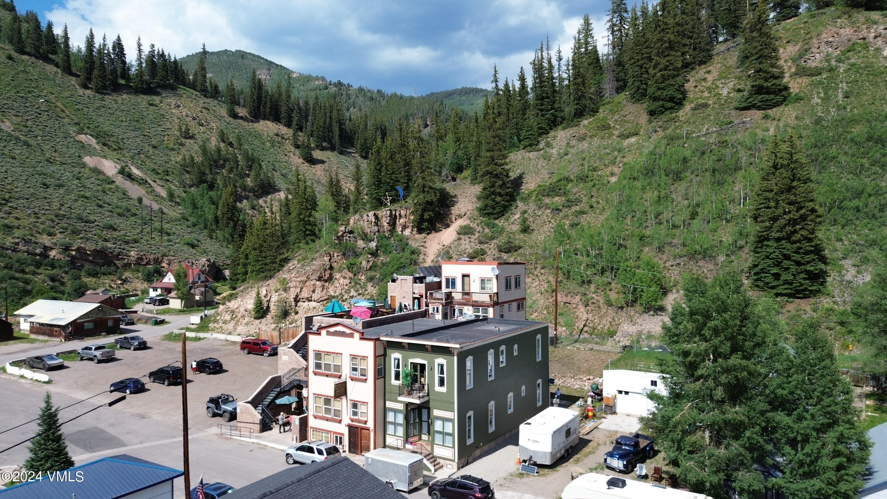 216 Eagle Street Red Cliff, CO 81649 - Photo 2 of 38 a view of a chairs and table in a backyard of the house