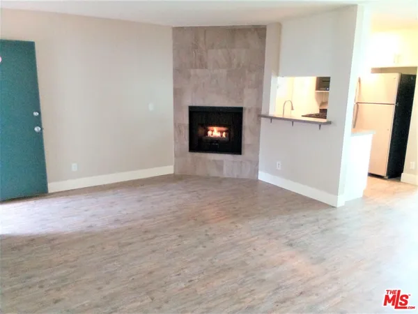 a view of an empty room with fire place
