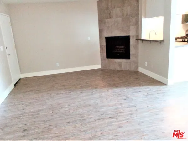 a view of an empty room with a fireplace