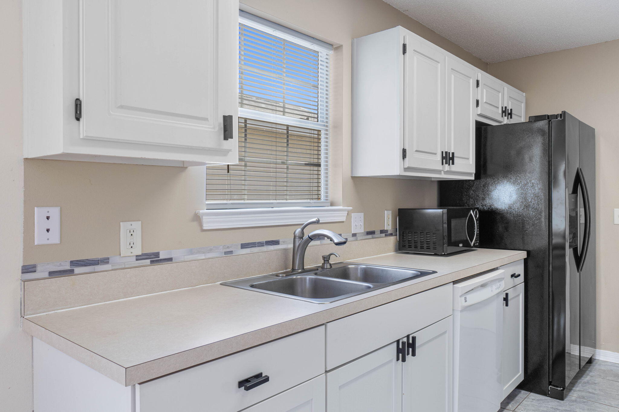 962 John Wayne Circle Fort Walton Beach, FL 32547 - Photo 11 of 25 a kitchen with stainless steel appliances granite countertop a sink stove and refrigerator