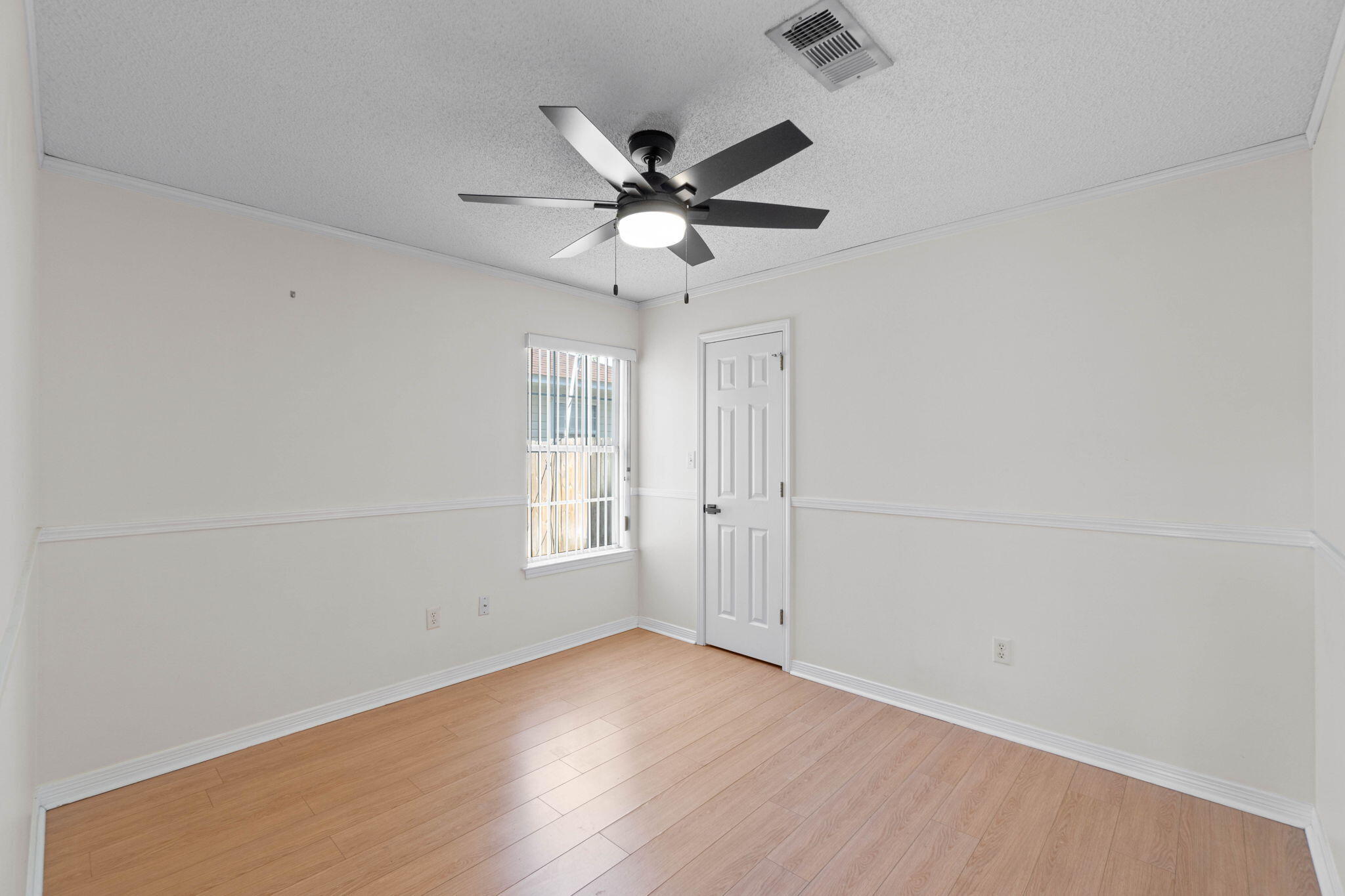 962 John Wayne Circle Fort Walton Beach, FL 32547 - Photo 13 of 25 an empty room with wooden floor fan and windows