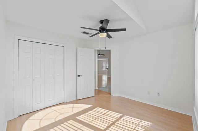 a view of a bedroom with a sink and refrigerator