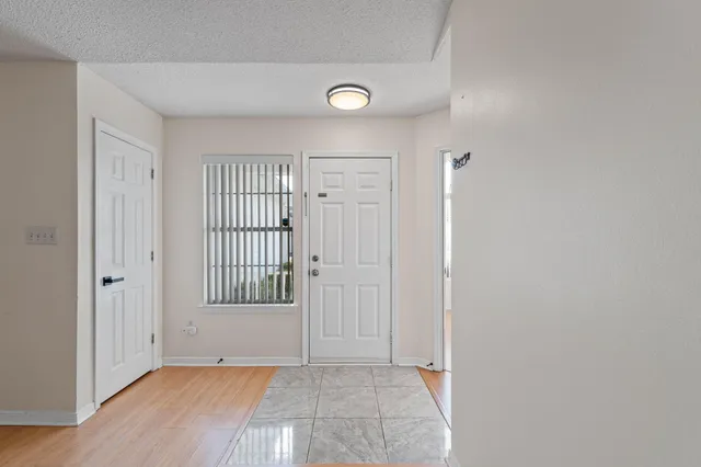 an empty room with windows and closet