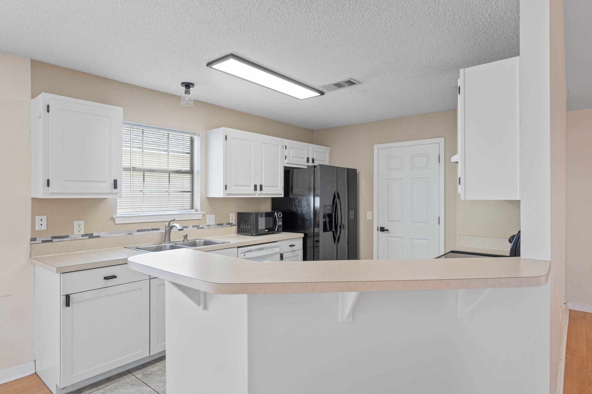 962 John Wayne Circle Fort Walton Beach, FL 32547 - Photo 10 of 25 a kitchen with stainless steel appliances a refrigerator sink and cabinets