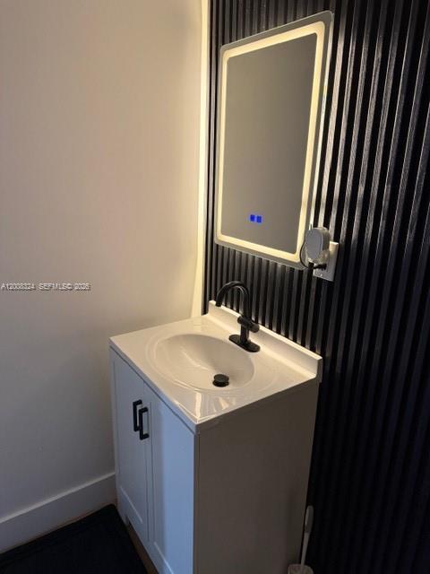 13003 Southwest 195th Street, Unit 2 Miami, FL 33177 - Photo 4 of 7 a bathroom with a sink a mirror and a toilet