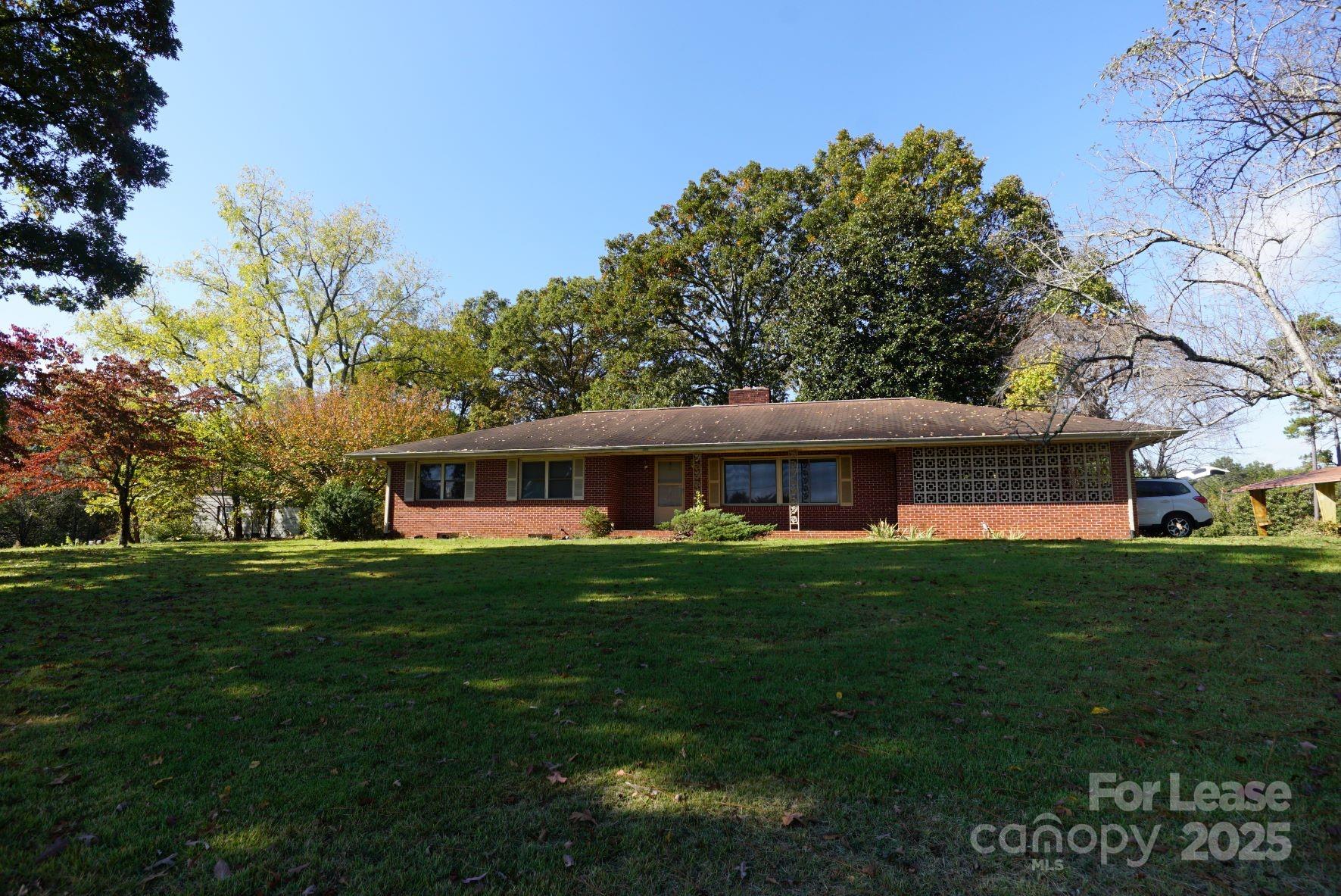 4705 Grace Chapel Road Granite Falls, NC 28630 - Photo 1 of 14 a front view of a house with a garden