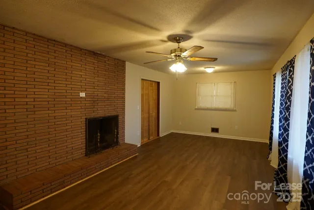 a view of an empty room with a fireplace