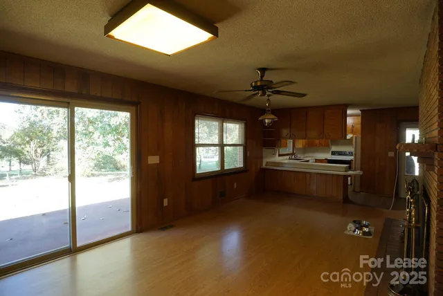 a open kitchen with stainless steel appliances granite countertop a stove and a refrigerator