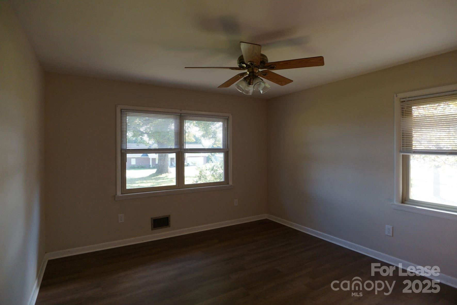 4705 Grace Chapel Road Granite Falls, NC 28630 - Photo 7 of 14 an empty room with wooden floor fan and windows