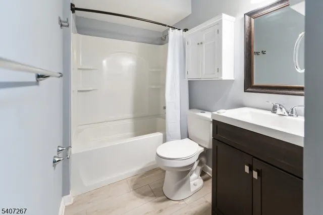 a bathroom with a sink toilet a mirror and shower
