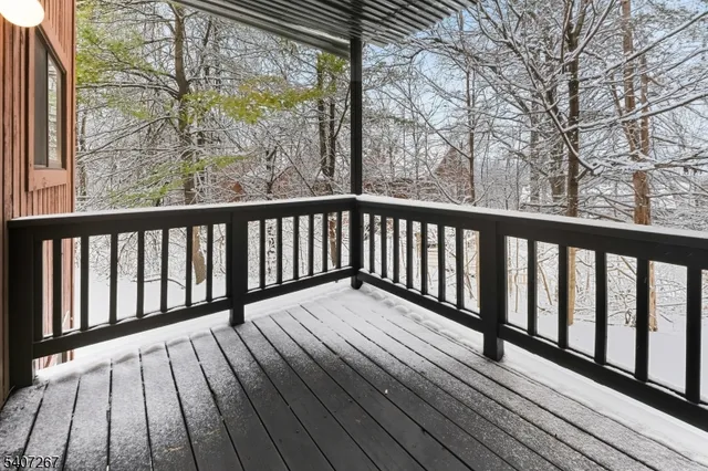 a balcony with wooden floor and fence