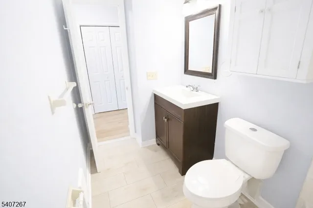 a white toilet sitting next to a bathroom sink