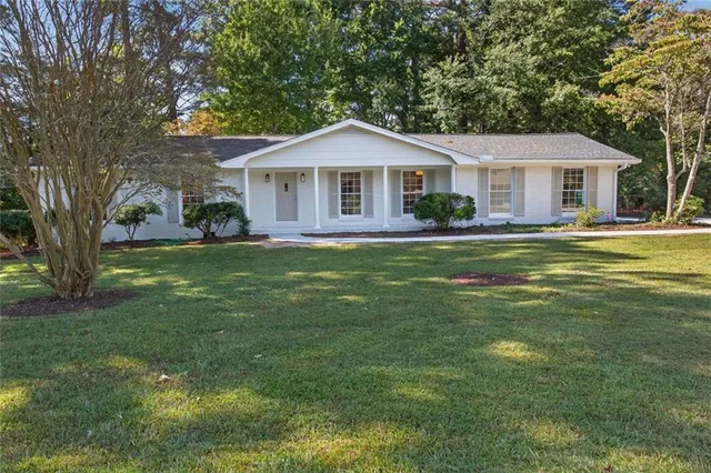a front view of a house with a garden