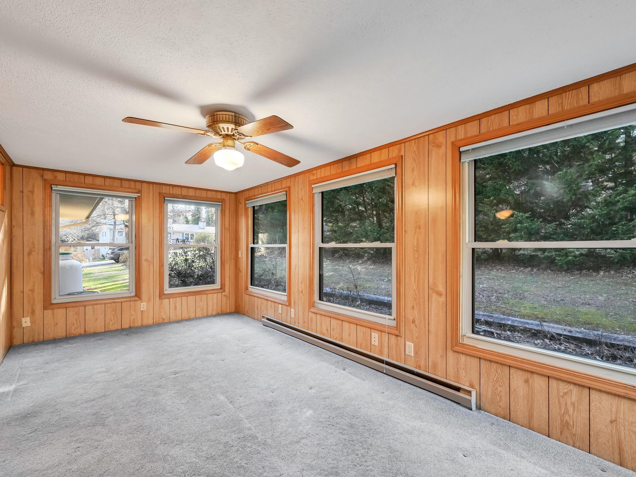 126 Apache Drive Hendersonville, NC 28739 - Photo 13 of 30 an empty room with windows and ceiling fan