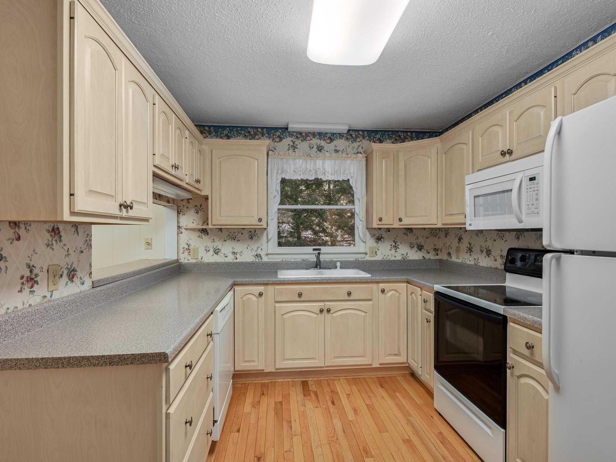126 Apache Drive Hendersonville, NC 28739 - Photo 7 of 30 a kitchen with cabinets a sink and appliances
