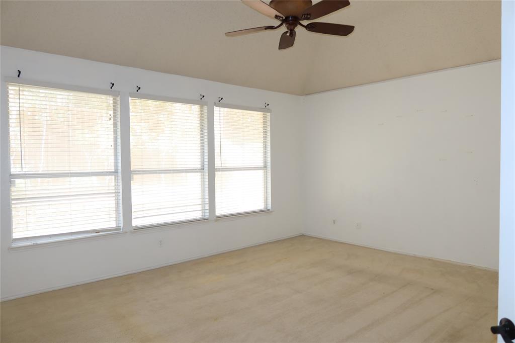 4419 Malvern Hill Road Grand Prairie, TX 75052 - Photo 12 of 24 a view of a big room with windows and chandelier fan