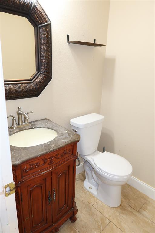 4419 Malvern Hill Road Grand Prairie, TX 75052 - Photo 13 of 24 a bathroom with a granite countertop toilet sink and mirror
