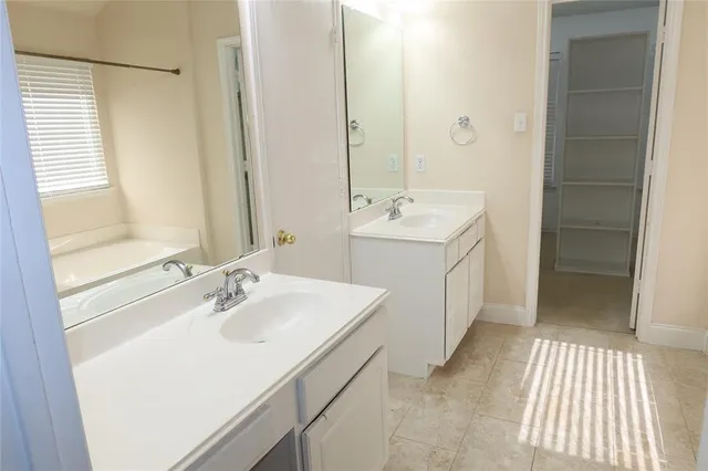 a bathroom with a sink a mirror and a shower