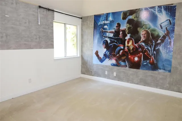 a view of a living room with clothes and a window