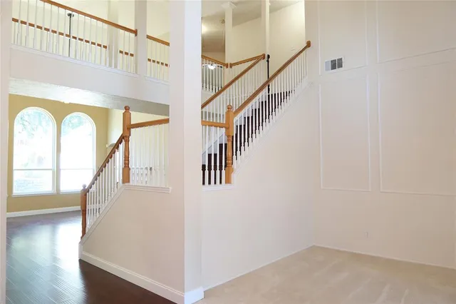 a view of staircase with wooden floor and a window