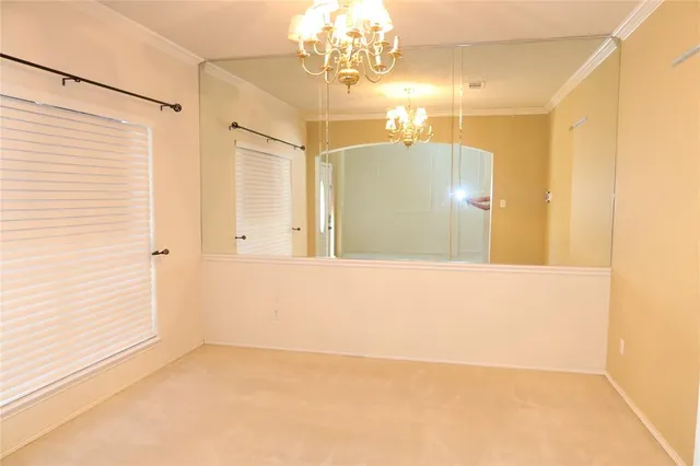 a view of a bathroom with a shower and a chandelier