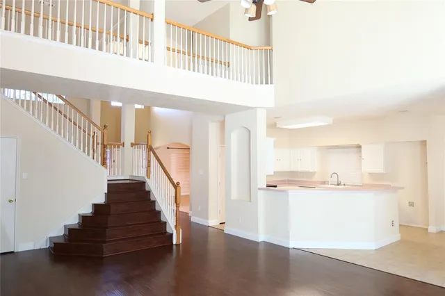 a view of entryway and kitchen with wooden floor