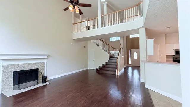 a view of a hallway with wooden floor and a fireplace