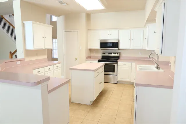 a kitchen with a sink stove and refrigerator
