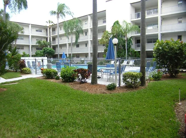 a view of swimming pool with chairs in patio