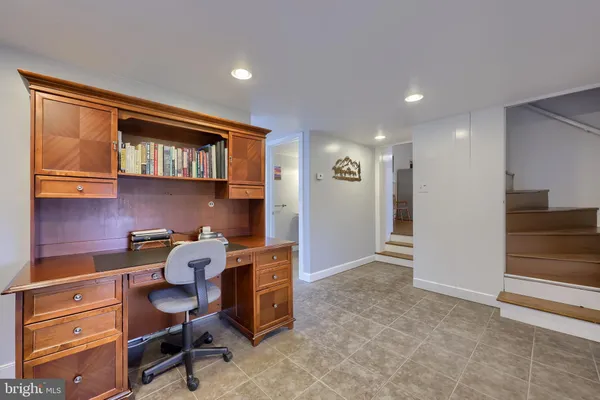 a bedroom with a bed a couch and dresser