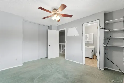 a view of an empty room with a ceiling fan