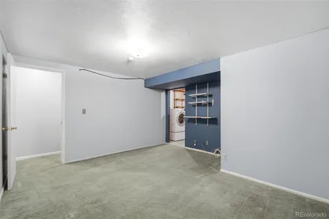 a view of an empty room with a closet