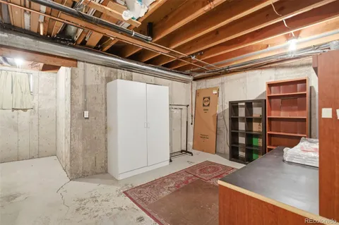 a view of empty room with wooden floor and closet