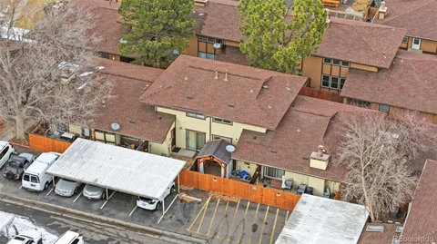 an aerial view of a house with a yard and potted plants