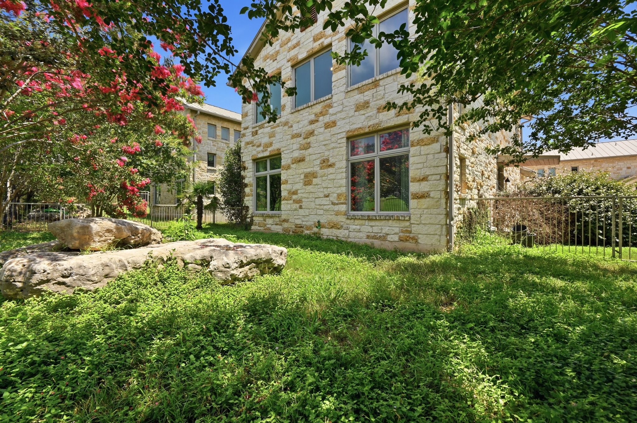 592 Farm To Market 967, Unit B Buda, TX 78610 - Photo 25 of 26 Viewed from the backyard, the home offers a peaceful outdoor retreat with a private fenced yard and inviting spaces to enjoy morning coffee or unwind at the end of the day.